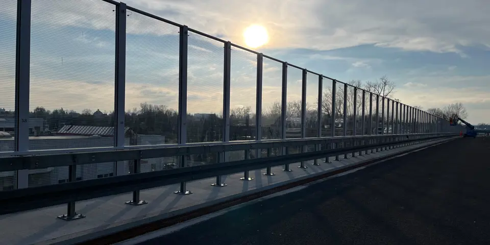 Lärmschutzwand der AWK GmbH mit transparenten Segmenten im Brückenbau